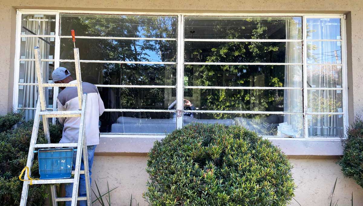 Glazer replacing broken glass panes on a steel window Get Glass